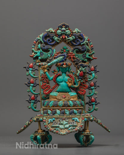 Hand-carved Manjushri statue holding flaming sword and lotus, crafted from precious stones and adorned with semi-precious gems.