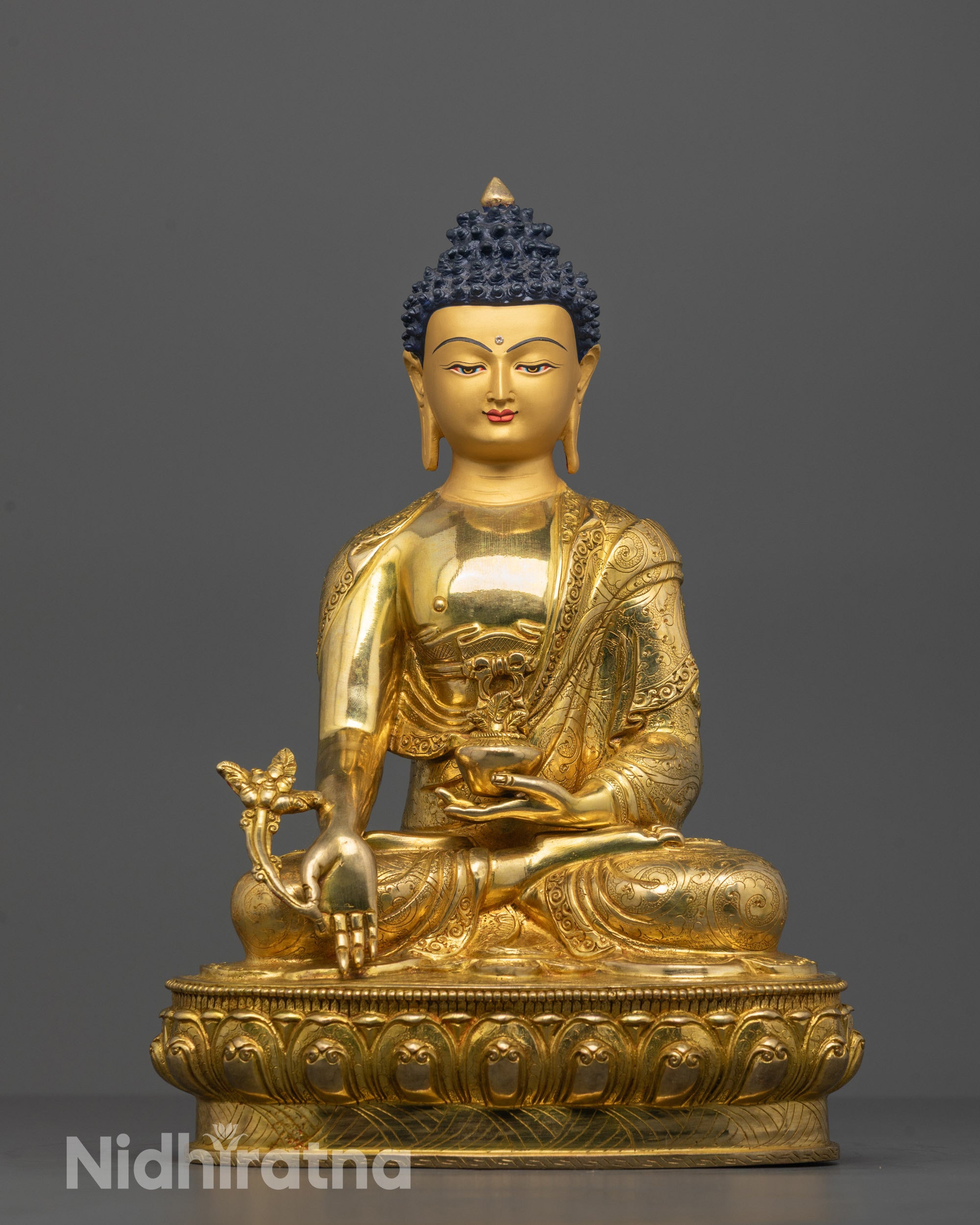 Hand-carved Medicine Buddha Statue seated on a lotus base holding medicine herb