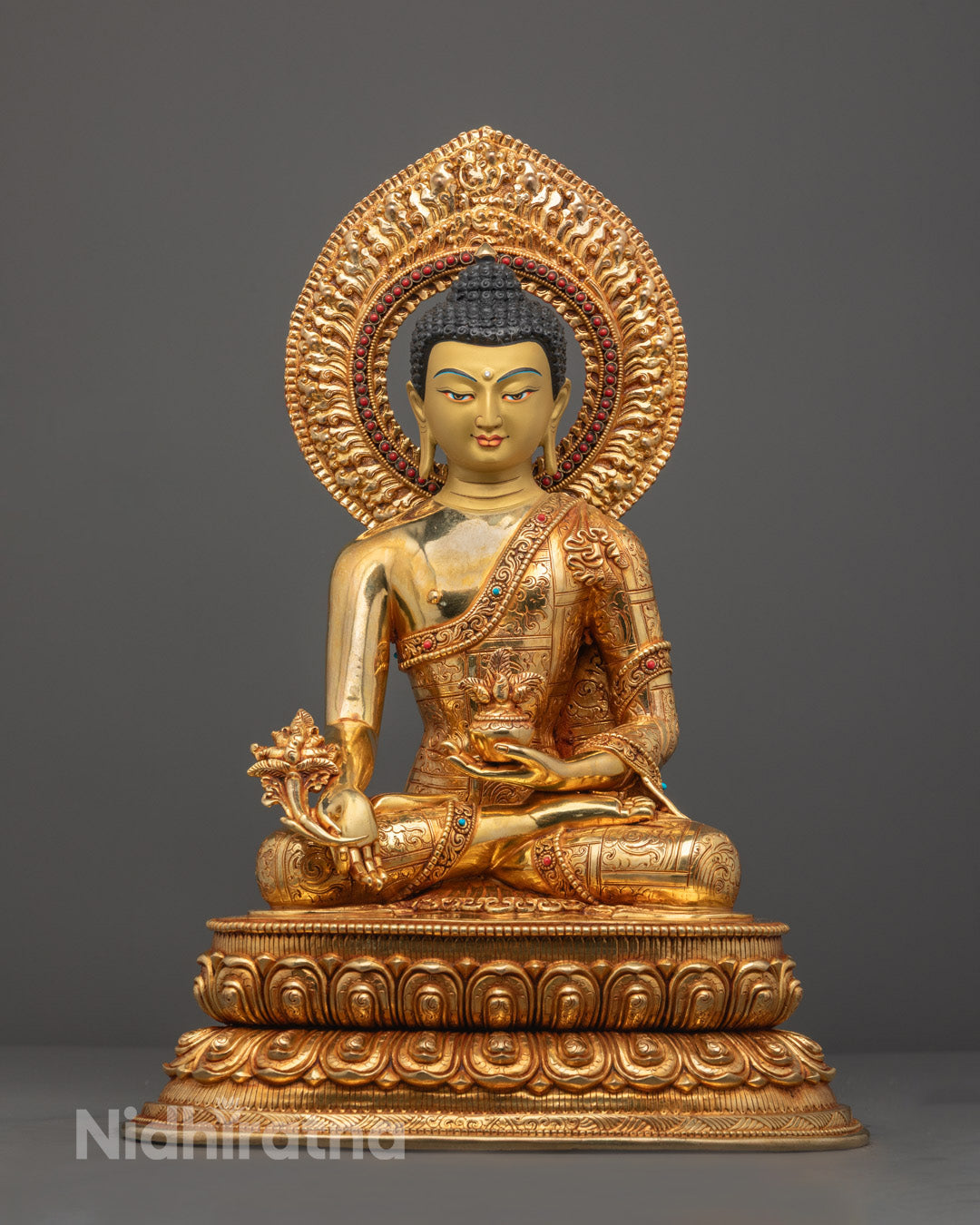 Hand-carved Medicine Buddha Statue with gold fire gilded finish seated on a lotus throne.