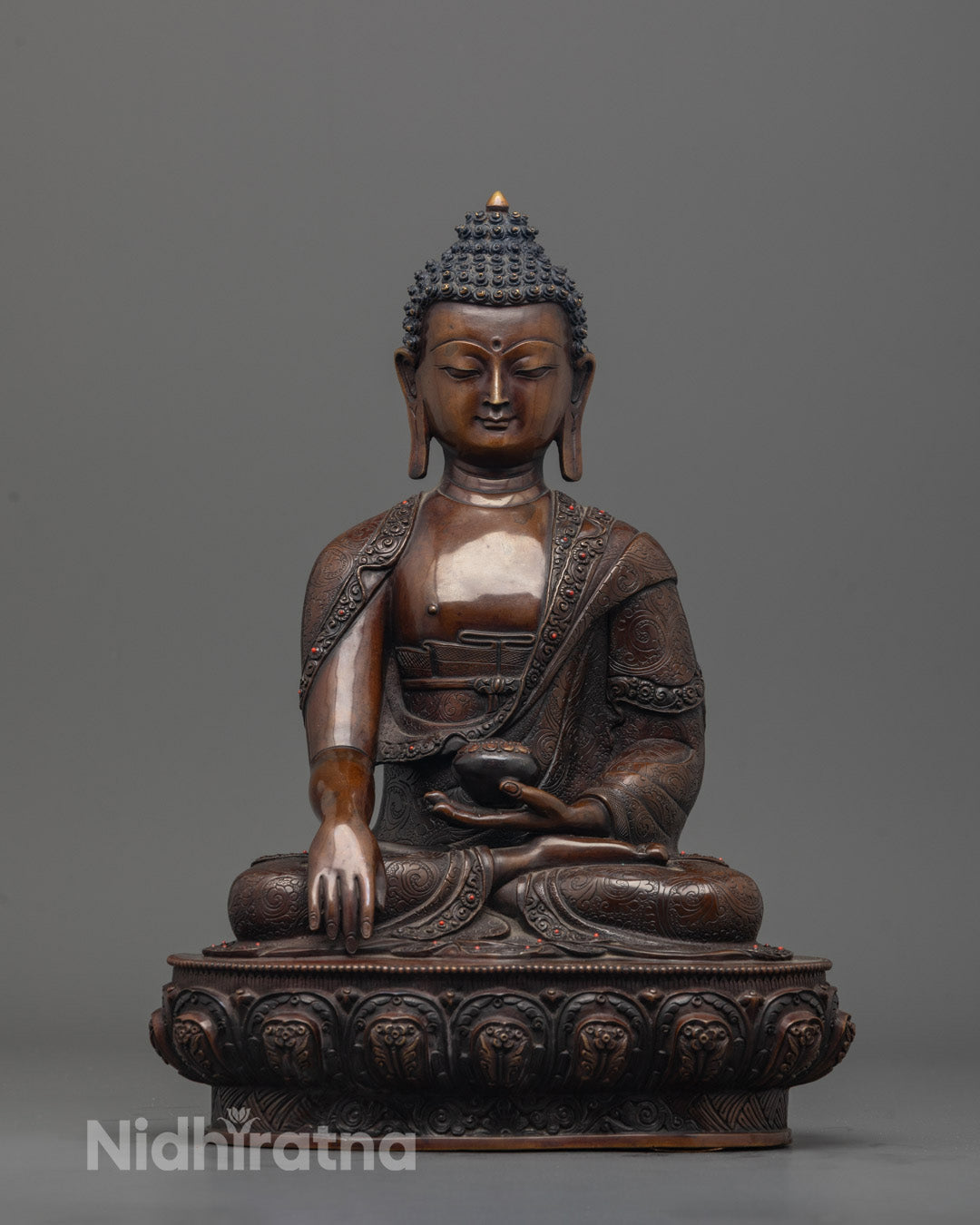 Hand-carved Shakyamuni Buddha Sculpture in oxidized copper seated on lotus base