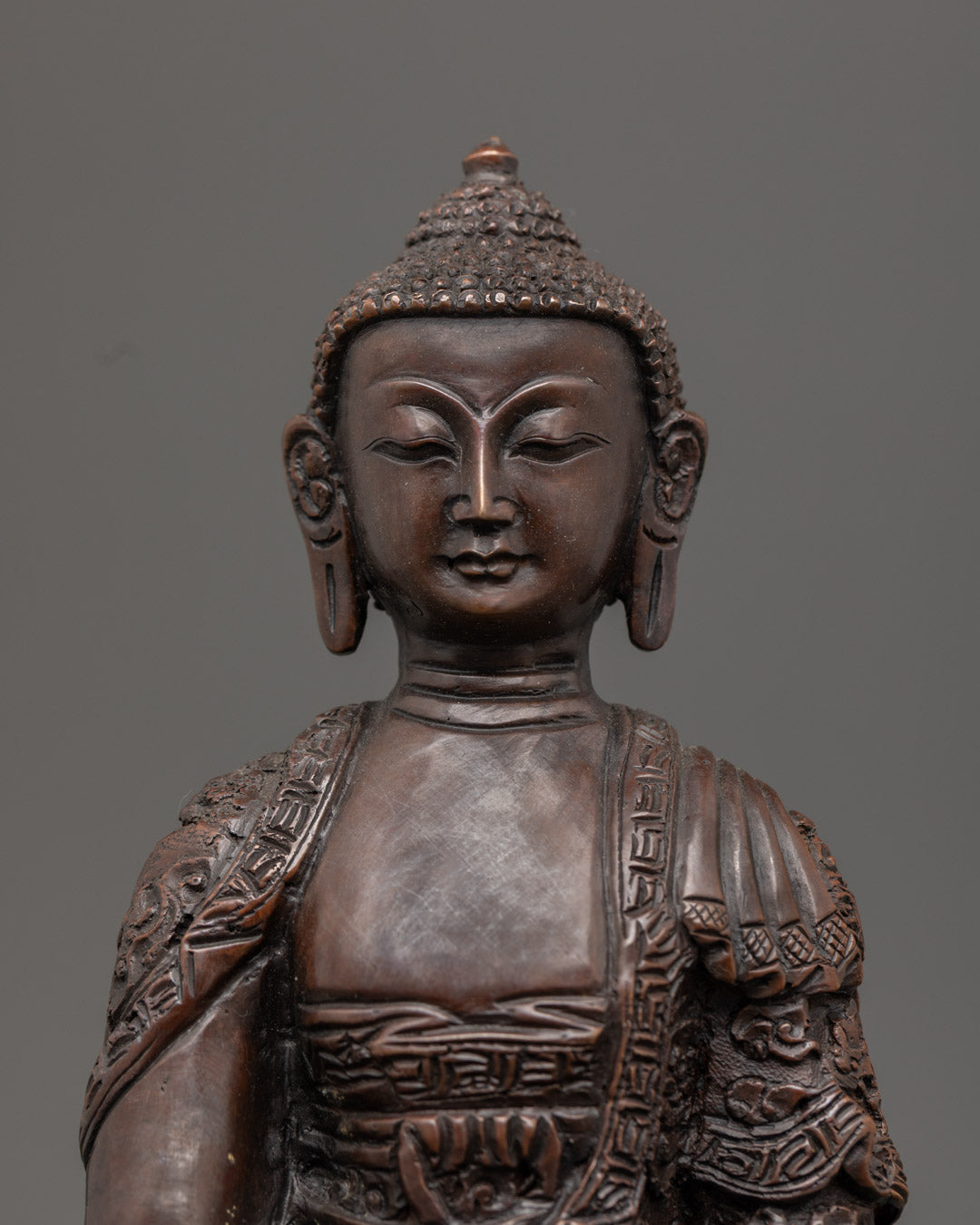 Hand-carved Shakyamuni Buddha Statue seated on lotus throne with oxidized copper finish, symbolizing enlightenment and inner peace.