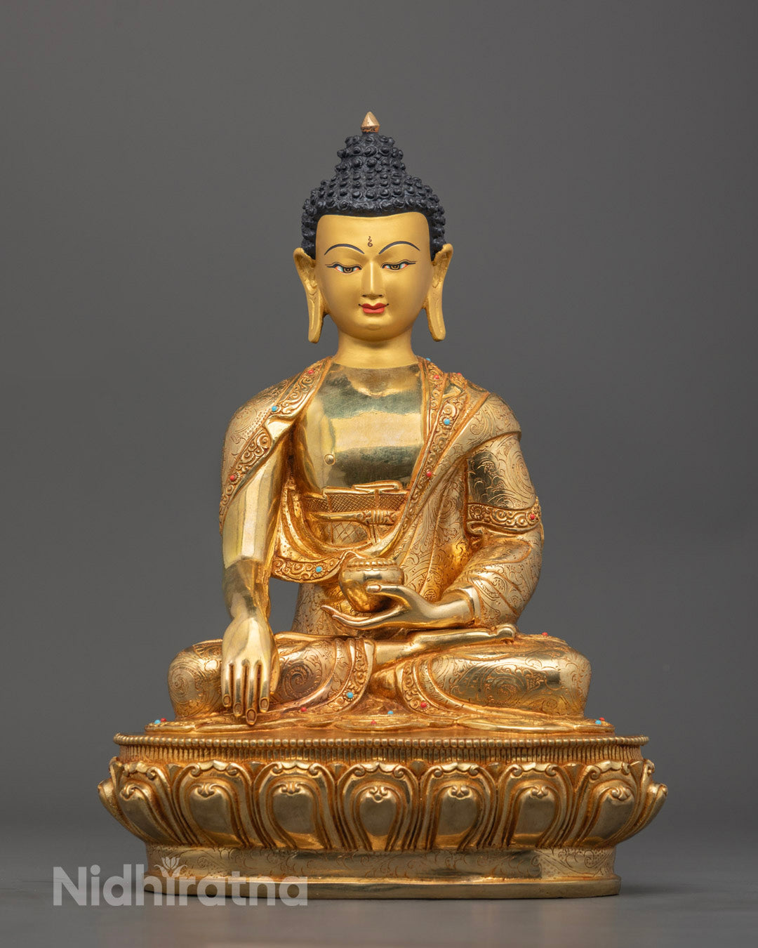 Hand-carved Shakyamuni Buddha Statue with 24k gold gilded face, seated in meditation posture, adorned with semi-precious stones and detailed robe.