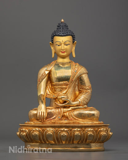 Hand-carved Shakyamuni Buddha Statue with 24k gold gilded face, seated in meditation posture, adorned with semi-precious stones and detailed robe.