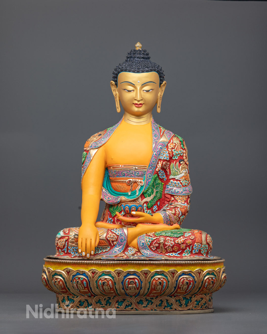 Hand-carved Shakyamuni Buddha statue in premium copper with 24k fire gilded gold and yellow acrylic paint, crafted in Nepal using traditional lost wax method.