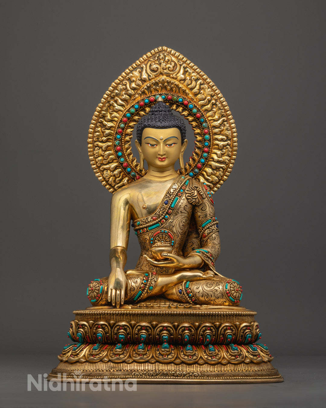 Hand-carved Shakyamuni Buddha statue made of oxidized copper with 24k gold fire-gilding and semi-precious stones, crafted in Nepal