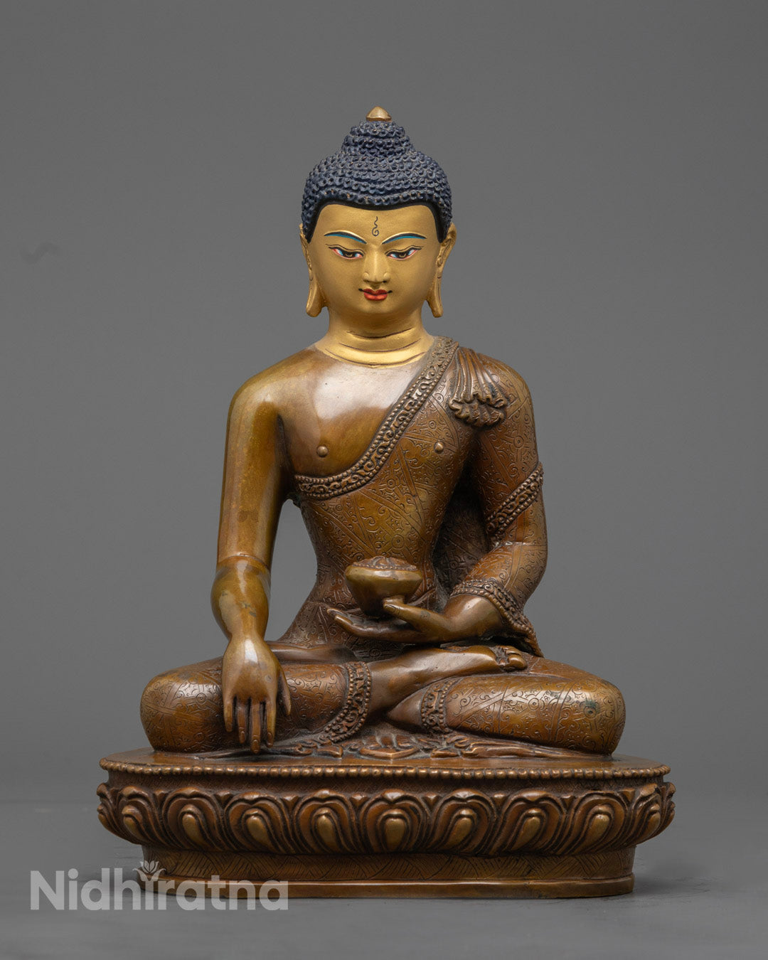 Hand-carved Shakyamuni Buddha statue seated on a lotus throne with oxidized copper finish and vibrant acrylic detailing.