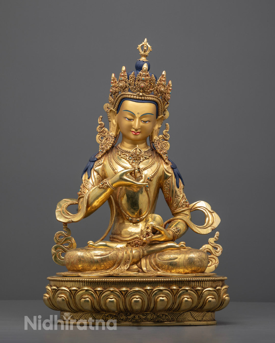 Hand-carved Vajrasattva Buddhist statue seated on lotus throne, adorned with 24k gold fire-gilding and semi-precious stones, crafted by Nepalese artisans.