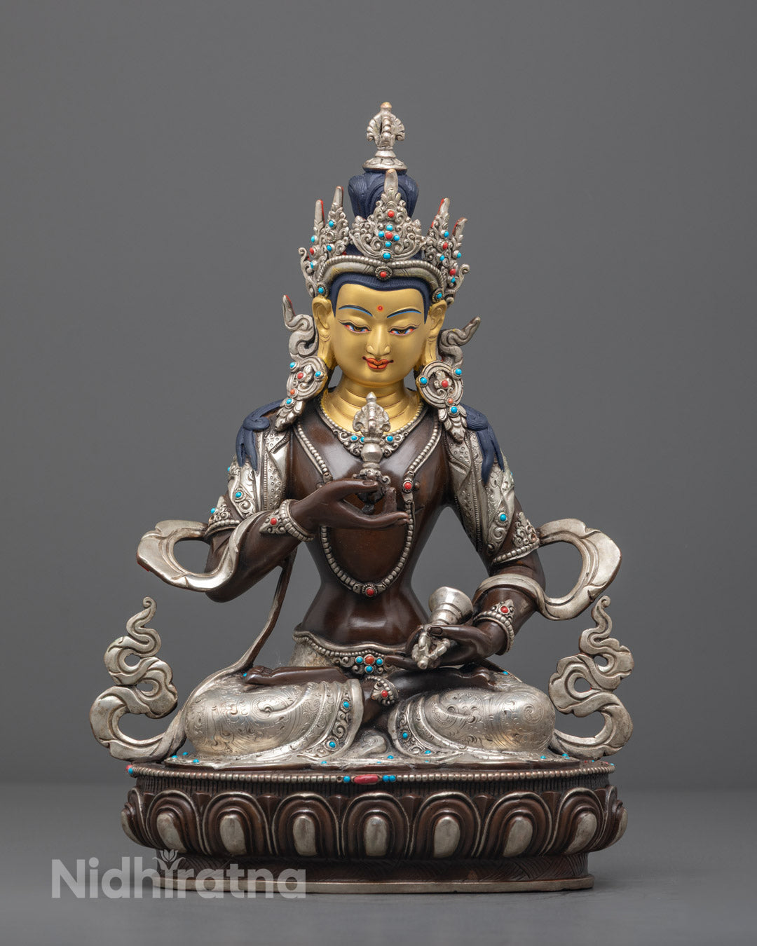 Hand-carved Vajrasattva statue in oxidized copper with silver-plated finish, featuring a serene gold-gilded face and vibrant semi-precious stone inlays.