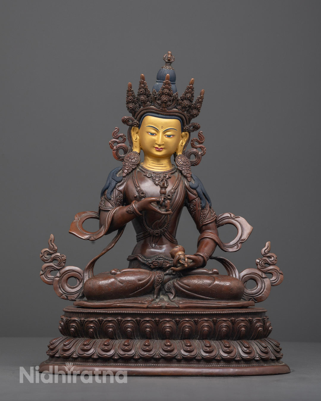 Hand-carved Vajrasattva statue with 24k gold-gilded face seated on lotus throne, crafted by Nepalese artisans.