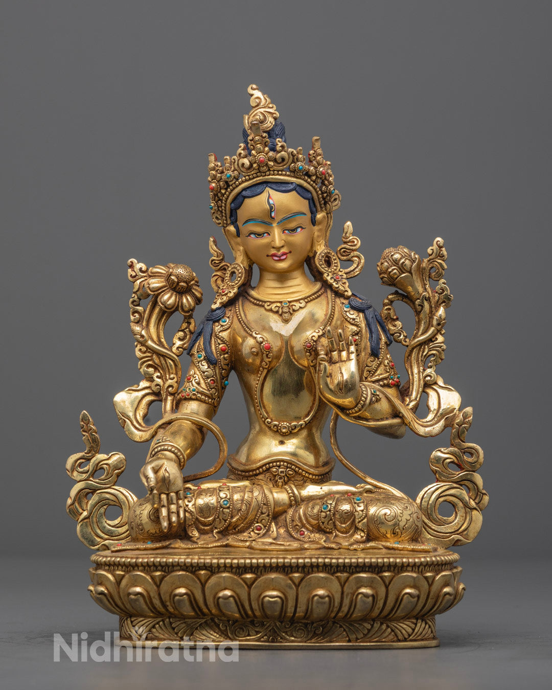 Hand-carved White Tara statue seated on a lotus throne with 24k gold fire-gilding, featuring a hollow chamber for auspicious mantra consecration, crafted by Nepalese artisan.