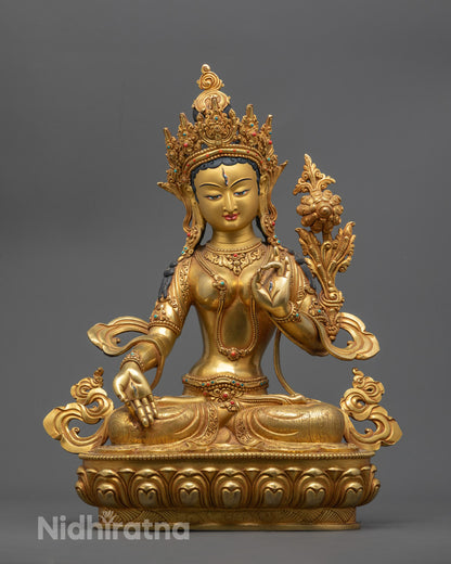 Hand-carved White Tara statue with 24k gold fire-gilding and colorful acrylic detailing, crafted by Nepalese artisan using lost wax method.