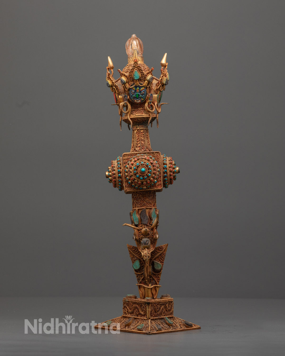 Front-view of Hand-carved copper Phurba adorned with semi-precious stones