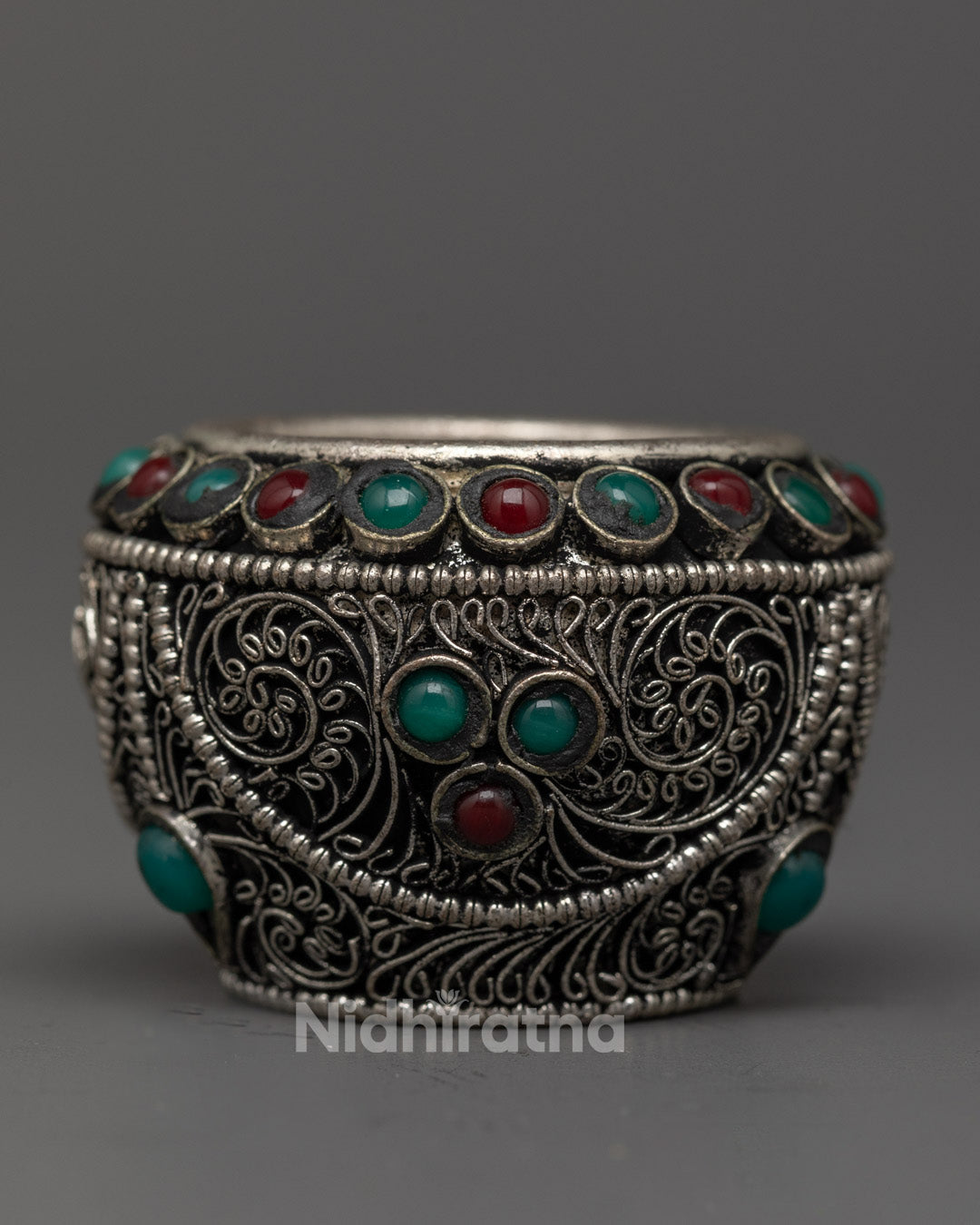 Hand-carved silver rice pot adorned with semi-precious stones