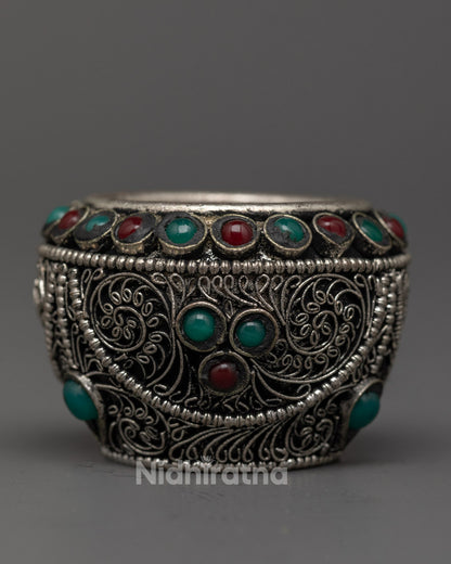 Hand-carved silver rice pot adorned with semi-precious stones