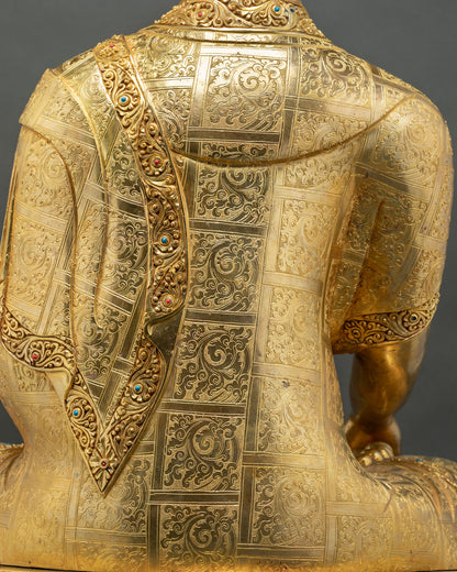 Hand-engraved floral robe pattern on back of gold gilded Nepalese Buddha statue