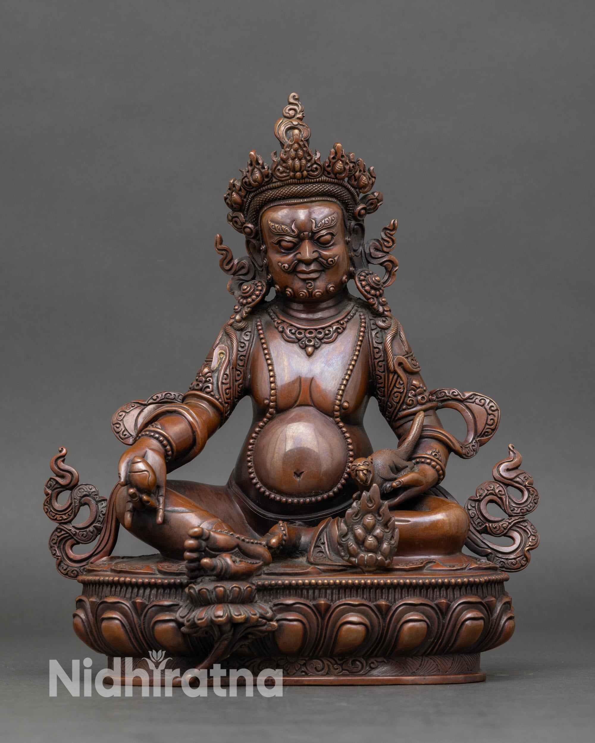 Handcrafted Dzambhala statue from Nepal, chemically oxidized copper, holding jewel-spitting mongoose for wealth and prosperity
