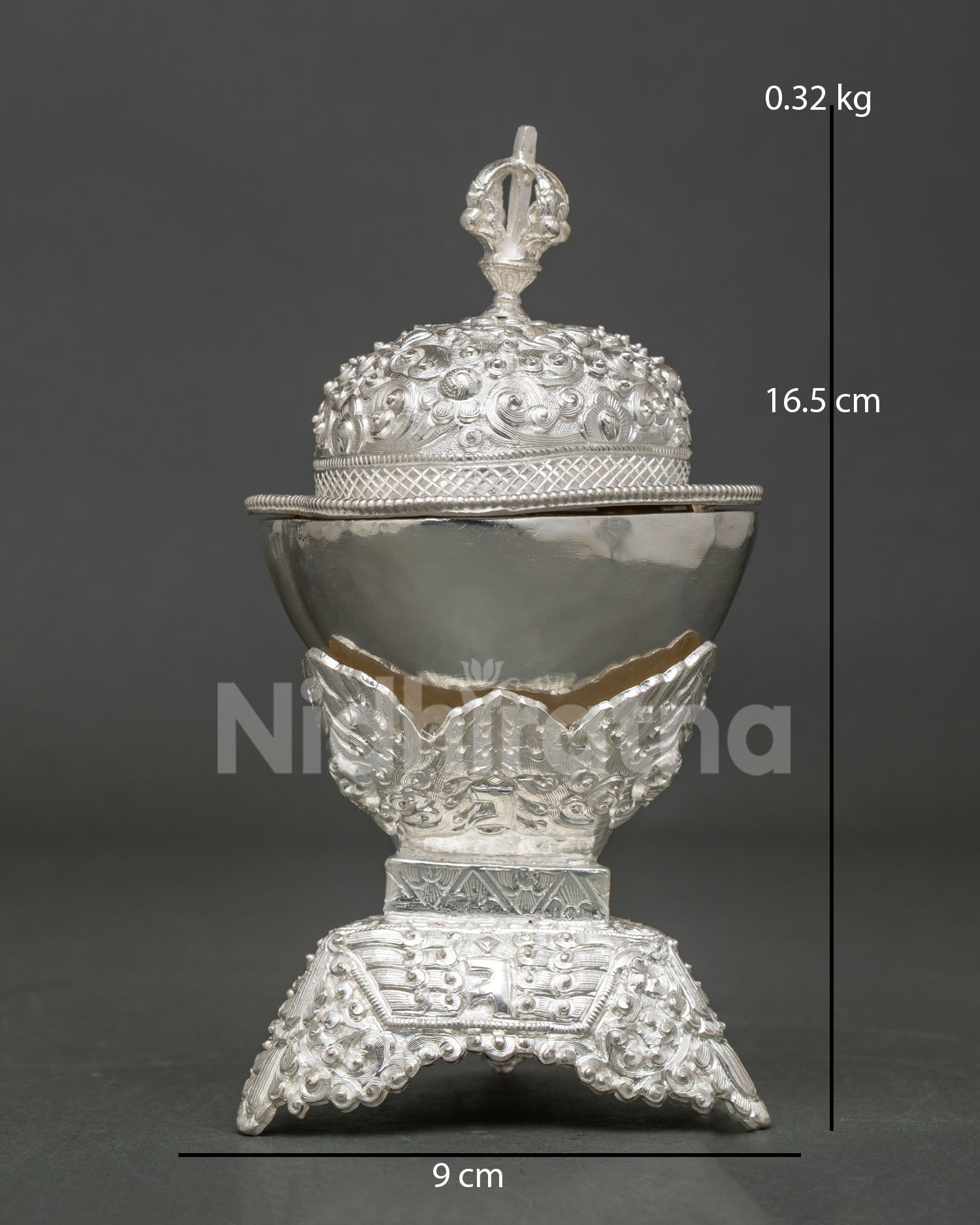 Handcrafted Kapala skull cup from Nepal with silver plating and floral carving.