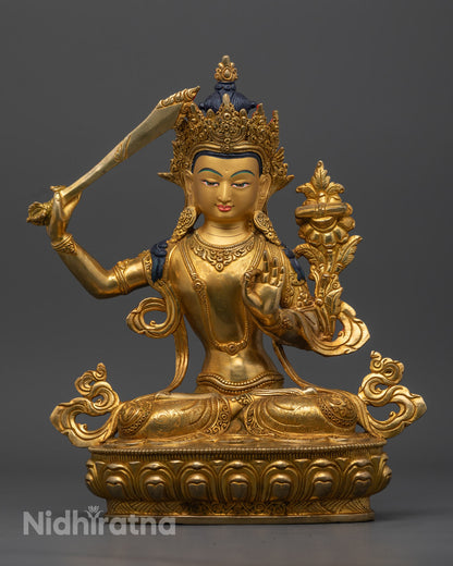 Handcrafted 24K gold gilded Manjushree Bodhisattva statue, seated on a lotus throne with the flaming sword of wisdom and the Prajnaparamita Sutra.