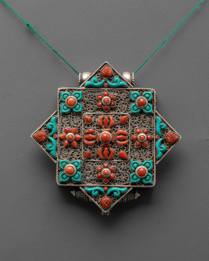 Handcrafted Bishwo Vajra Locket front view with silver, coral double vajra, and turquoise detail