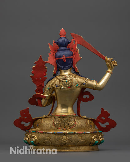 Handcrafted Bodhisattva Manjushri Statue from Nepal seated on lotus base with Dharma Wheel and deer carvings.
