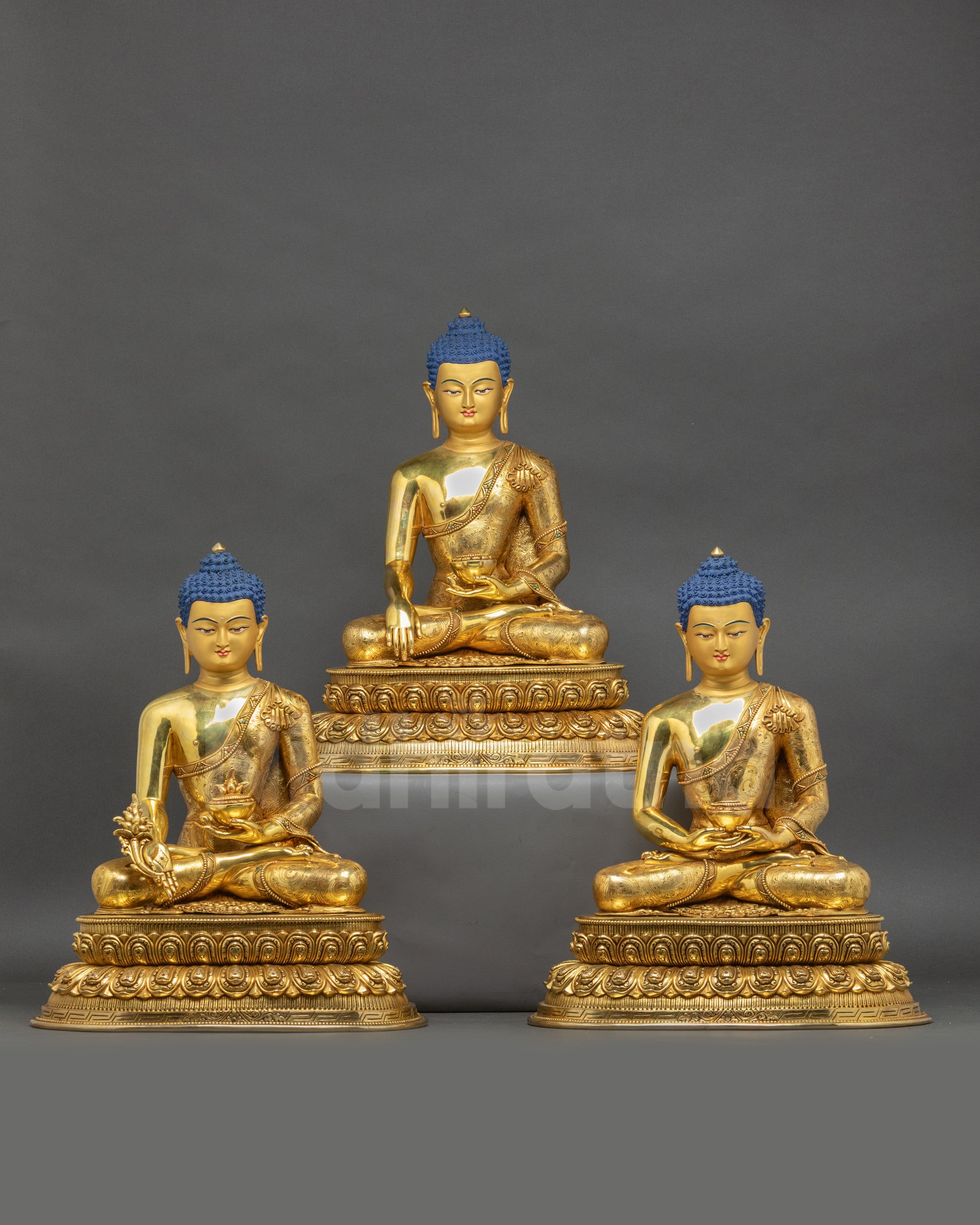 Handcrafted Buddhist Masters Statue Set featuring Medicine Buddha, Shakyamuni Buddha, and Amitabha Buddha with gold-gilded faces