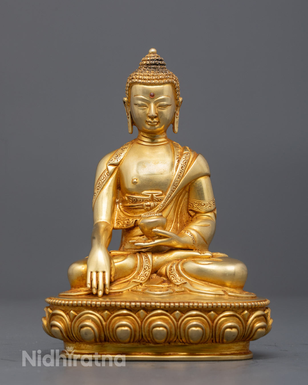 Handcrafted Gautam Buddha Statue with gold gilded face and fire gilded body showcasing detailed Kasaya robe and vibrant acrylic paint