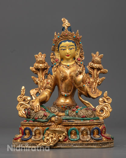 Handcrafted Green Tara statue with 24k gold-gilded face and old fire gold-gilded alloy body, adorned with turquoise, coral, and lapis lazuli stones, seated on a lotus throne.
