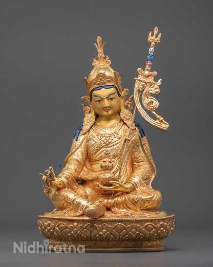 Handcrafted Guru Padmasambhava Statue with 24k gold-gilded face, fire-gilded gold body, and vibrant acrylic-painted details – Tibetan Buddhist art for spiritual altar.