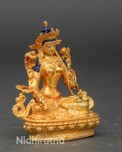 Handcrafted Himalayan White Tara statue on altar, gold fire-gilded copper