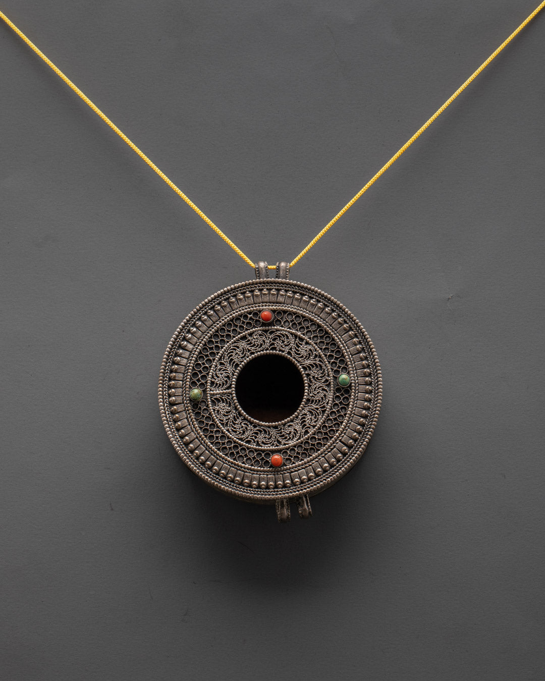 Handcrafted Mandala Locket from Patan, Nepal, displayed on a dark background highlighting