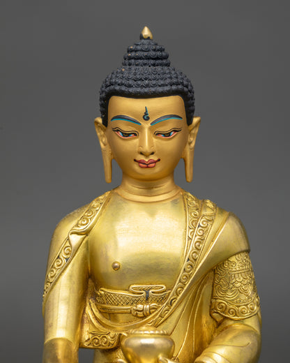 Handcrafted Shakya Thubpa sculpture by Newari artisans featuring serene gold-painted face and intricate robes