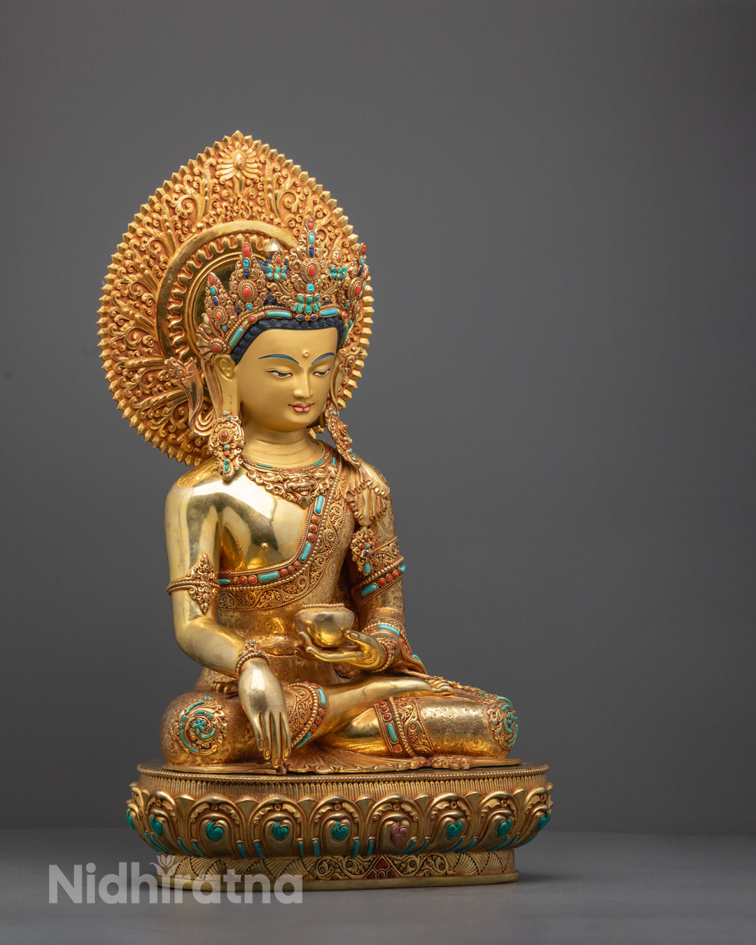 Handcrafted Shakyamuni Buddha statue from Nepal featuring copper base with 24k gold fire gilding, detailed with acrylic colors and semi-precious stones symbolizing compassion and healing.
