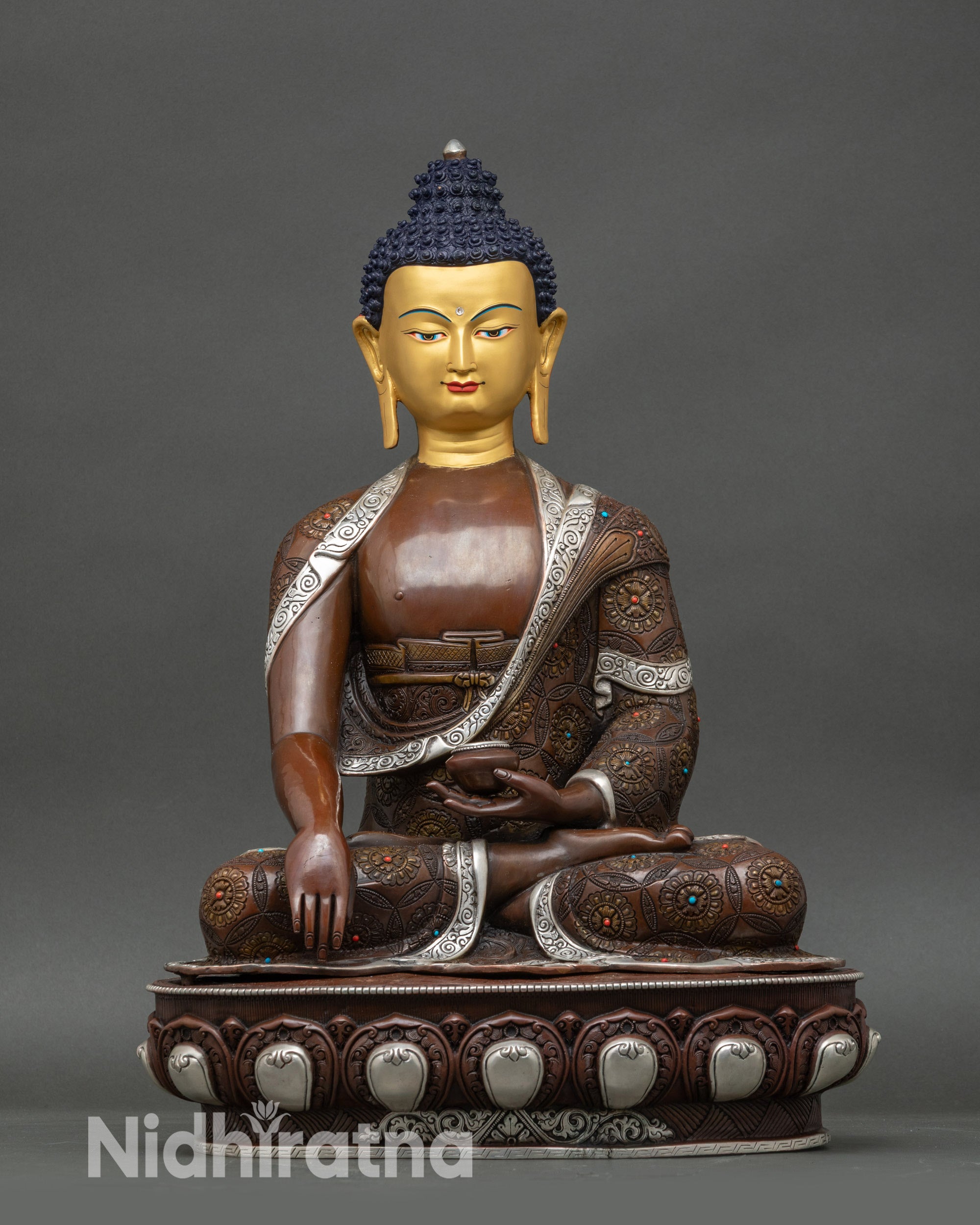 Handcrafted Shakyamuni Buddha statue from Patan, Nepal with 24K gold-painted face and silver finish