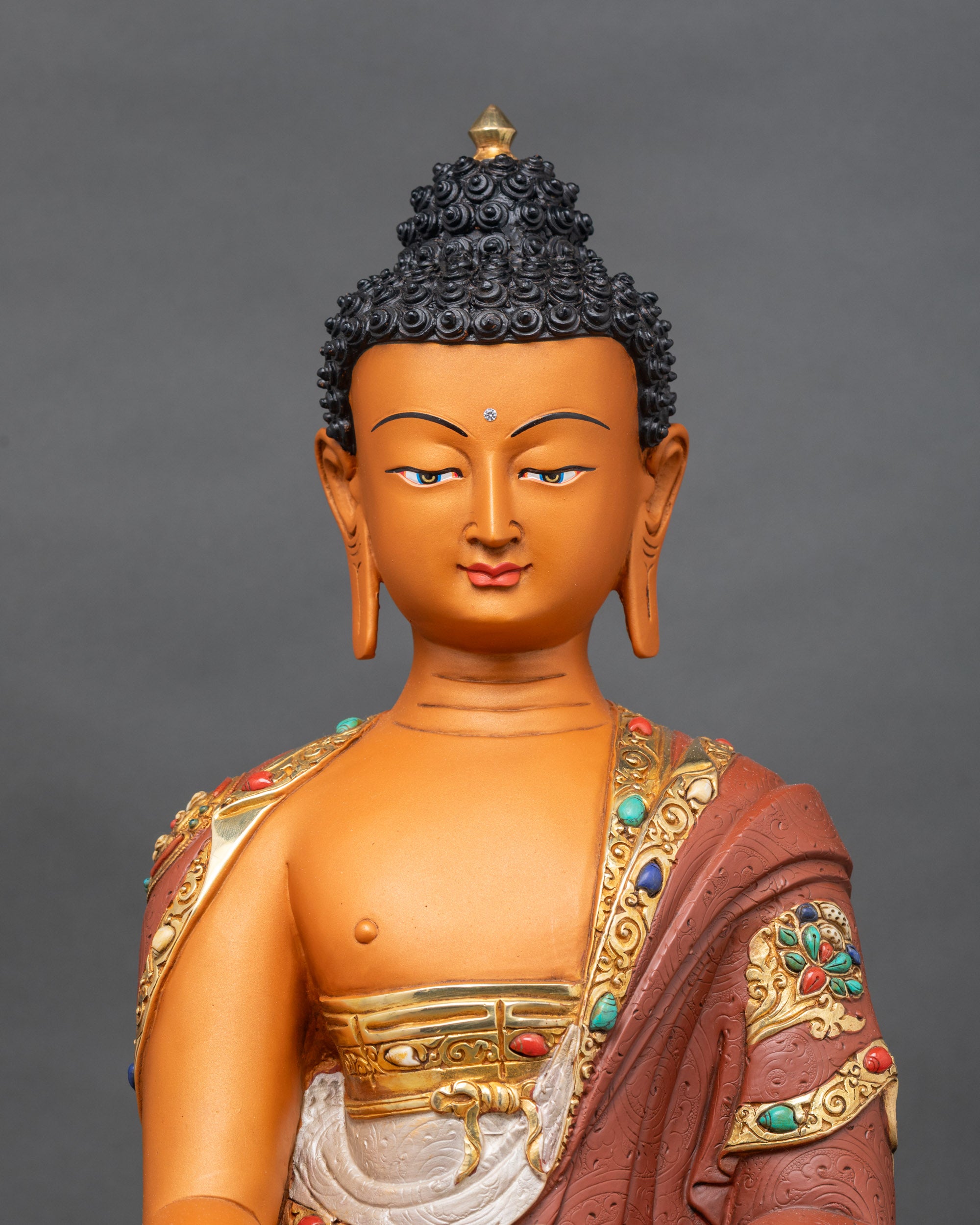 Handcrafted Shakyamuni Buddha statue showing detailed copper and gold features