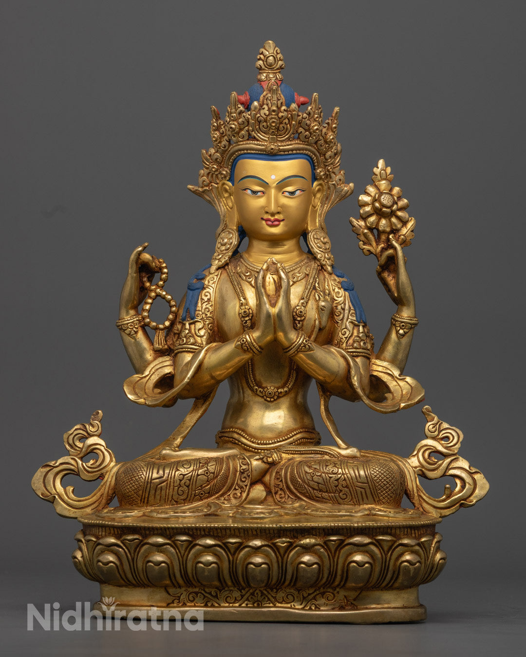 Handcrafted Tibetan Chenrezig statue with gold gilding on the face and 24k gold fire gilding on a copper alloy base, seated on a lotus throne, radiating spiritual grace and compassion.