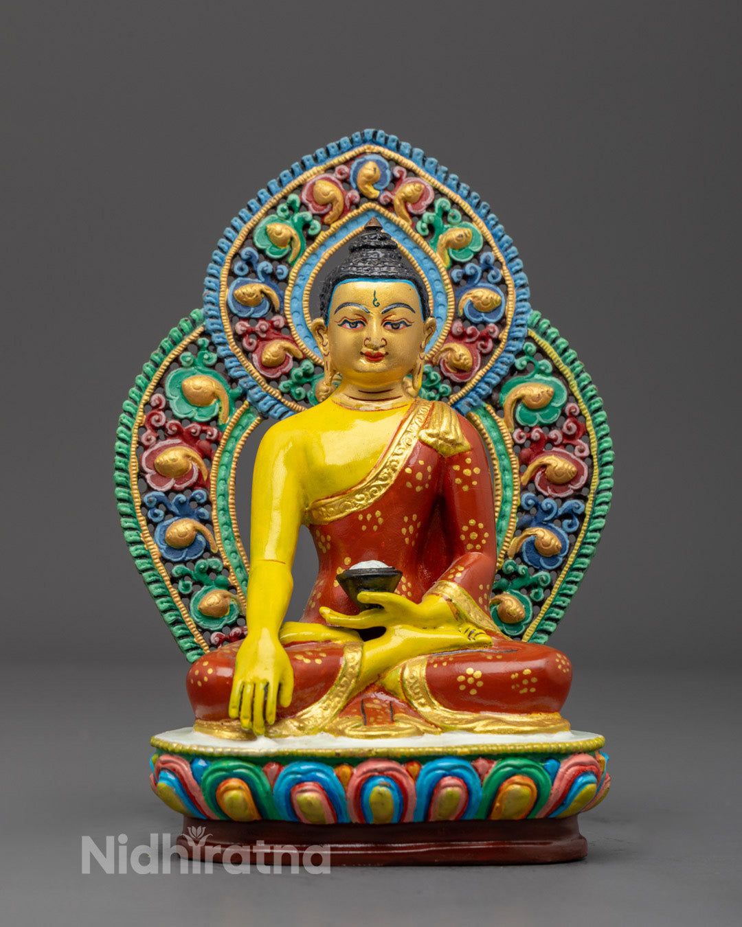 Handcrafted Yellow Shakyamuni Buddha statue with gold gilded throne, detailed facial features, and intricate robes, made in Nepal.