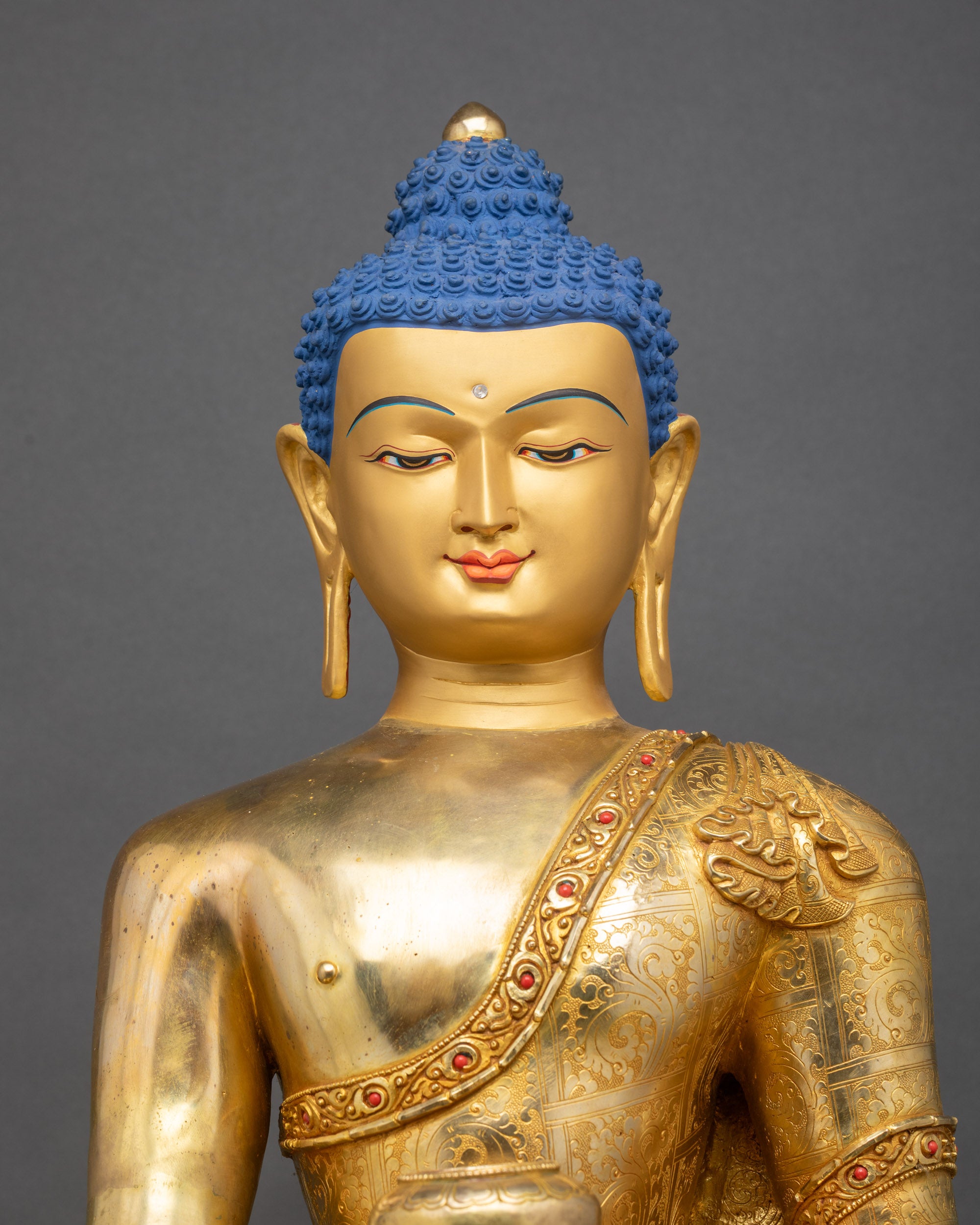 Handcrafted copper Buddha statue featuring gold fire-gilding, turquoise inlays, and lotus flower pedestal