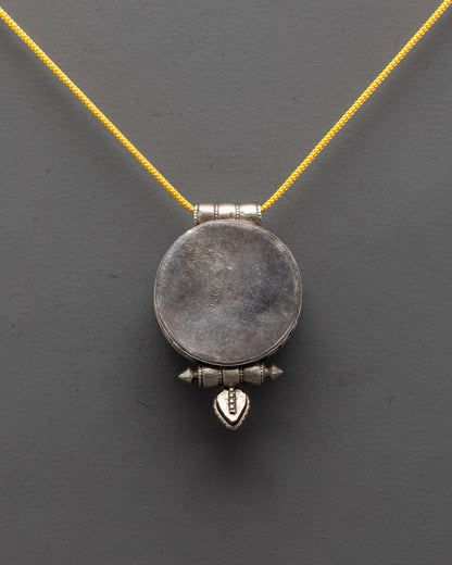 Handcrafted silver shell locket with intricate filigree design