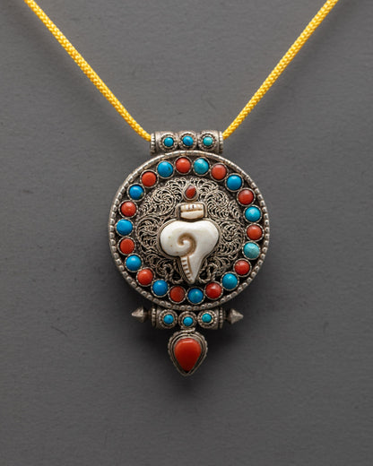 Handcrafted silver shell locket with intricate filigree design and colorful semi-precious stones