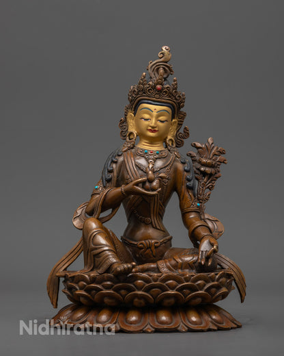 Handmade Oxidized Manjushri Statue with 24k gold-gilded face, copper body, and semi-precious stone inlays – symbol of wisdom and enlightenment.