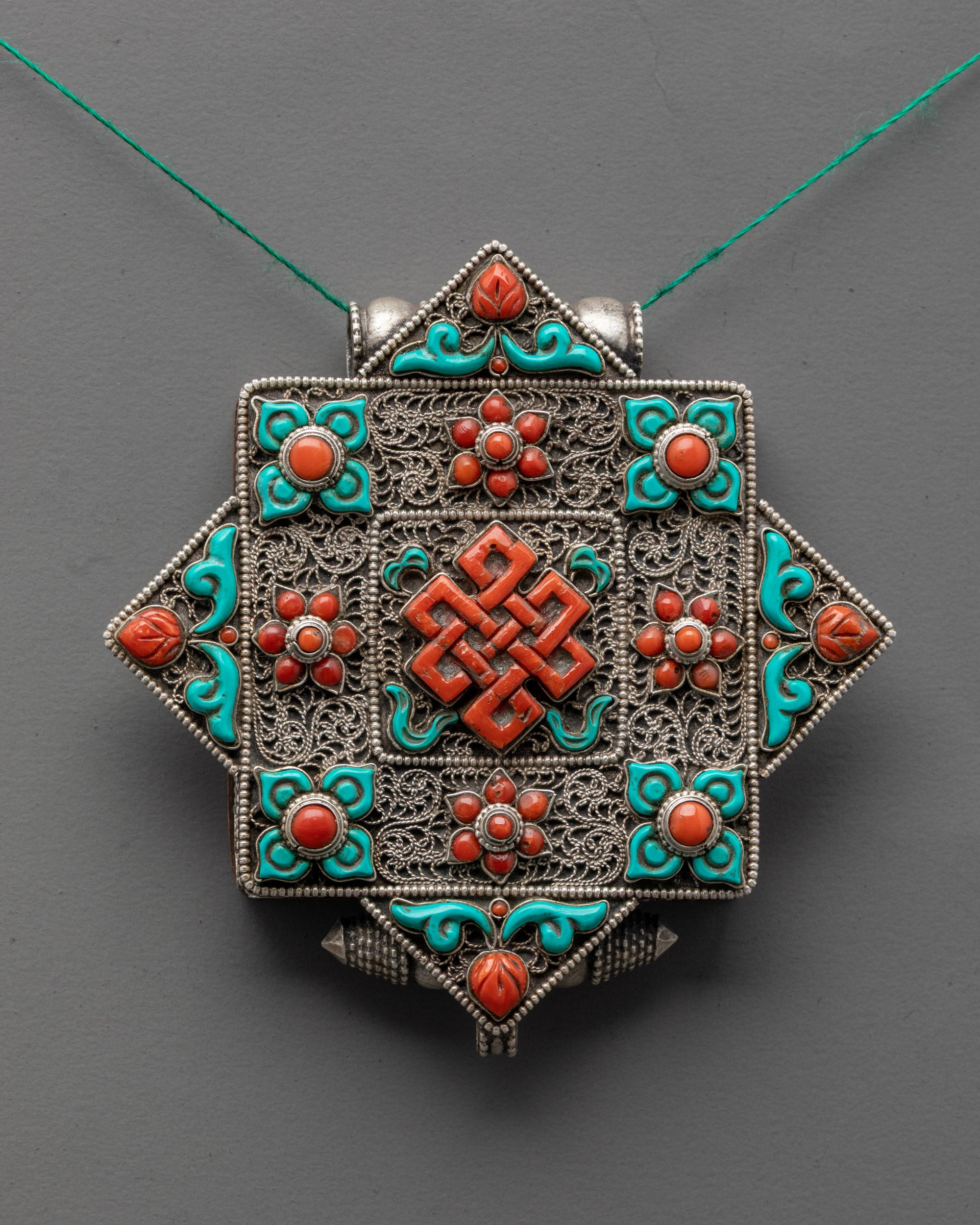 Handmade Tibetan Endless Knot Locket Necklace featuring turquoise and coral semi-precious stones
