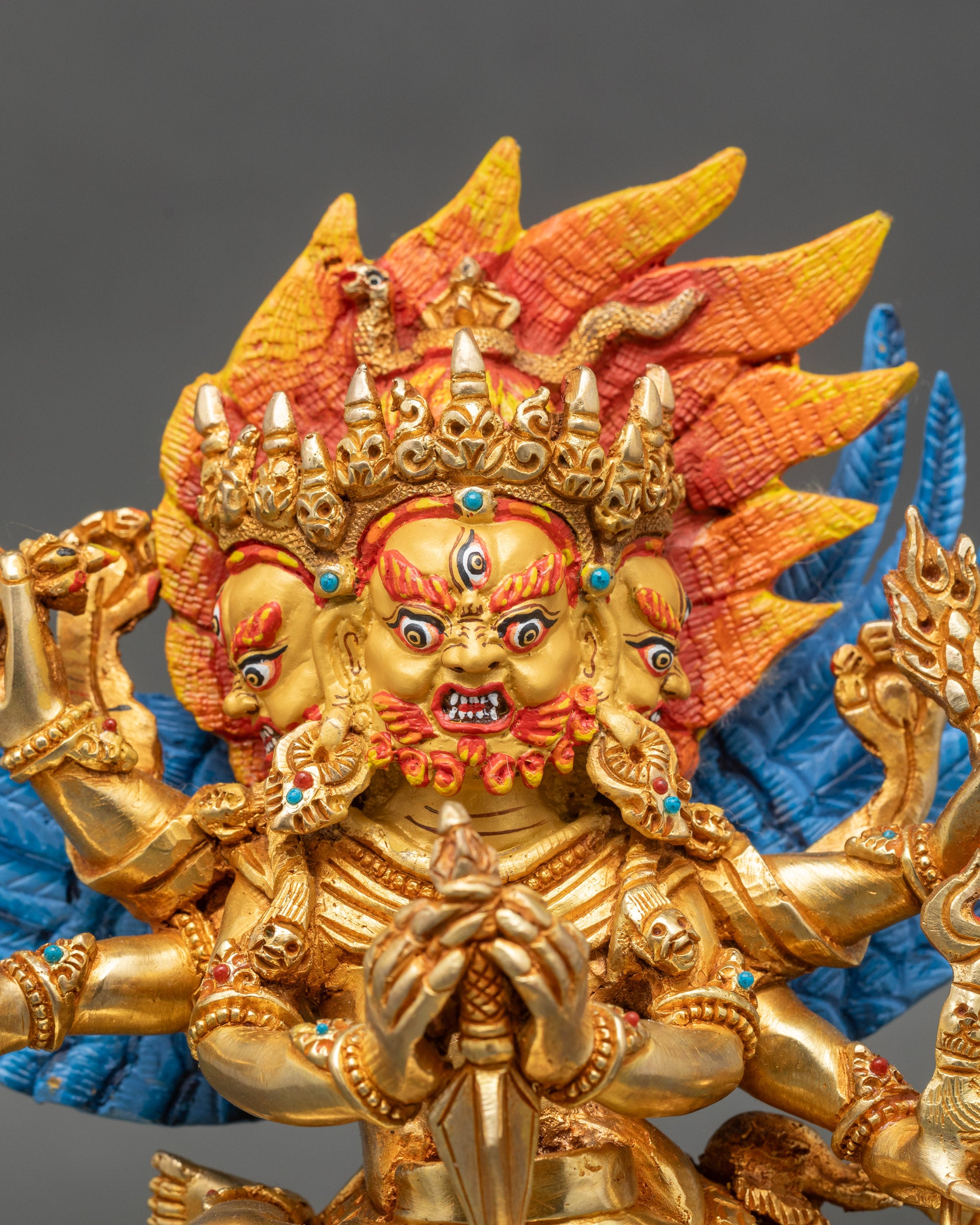 Hayagriva red face close-up with piercing eyes and ornate crown details