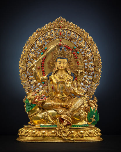 Head-on view of lion-seated Simhada Manjushri statue with gold fire-gilding and radiant halo