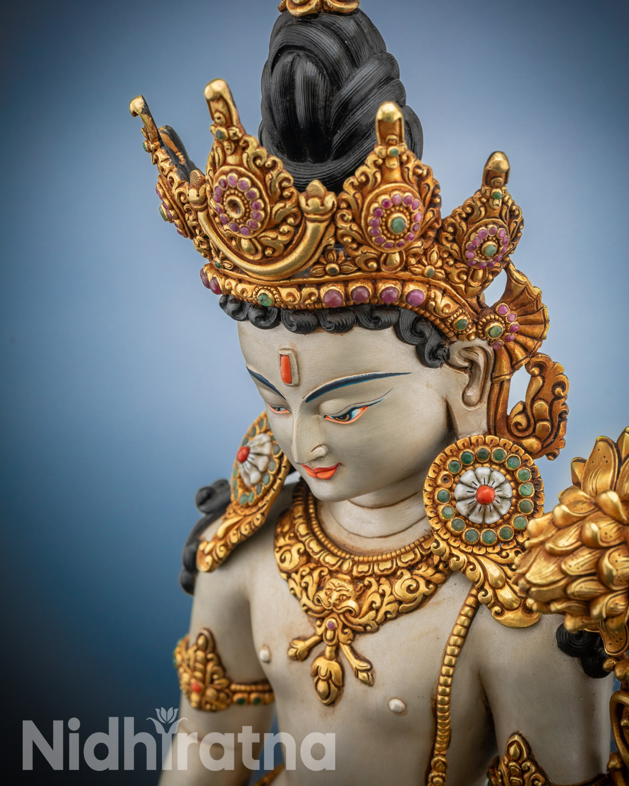 High-angle shot of Padmapani Lokeshvara standing on lotus seat with gold-gilded details
