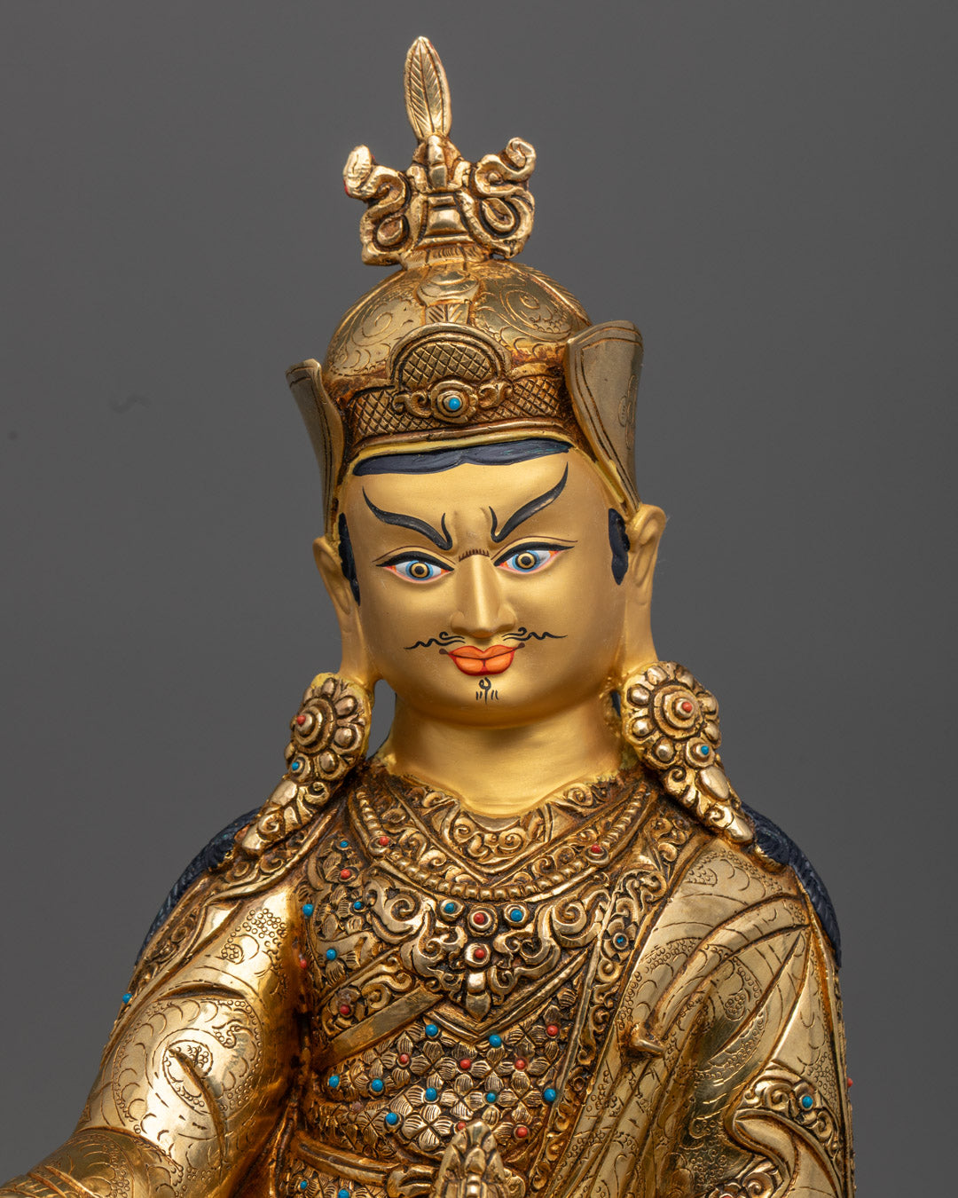 High-quality Tibetan Guru Rinpoche statue featuring detailed robe and jewelry carvings for sacred altar spaces