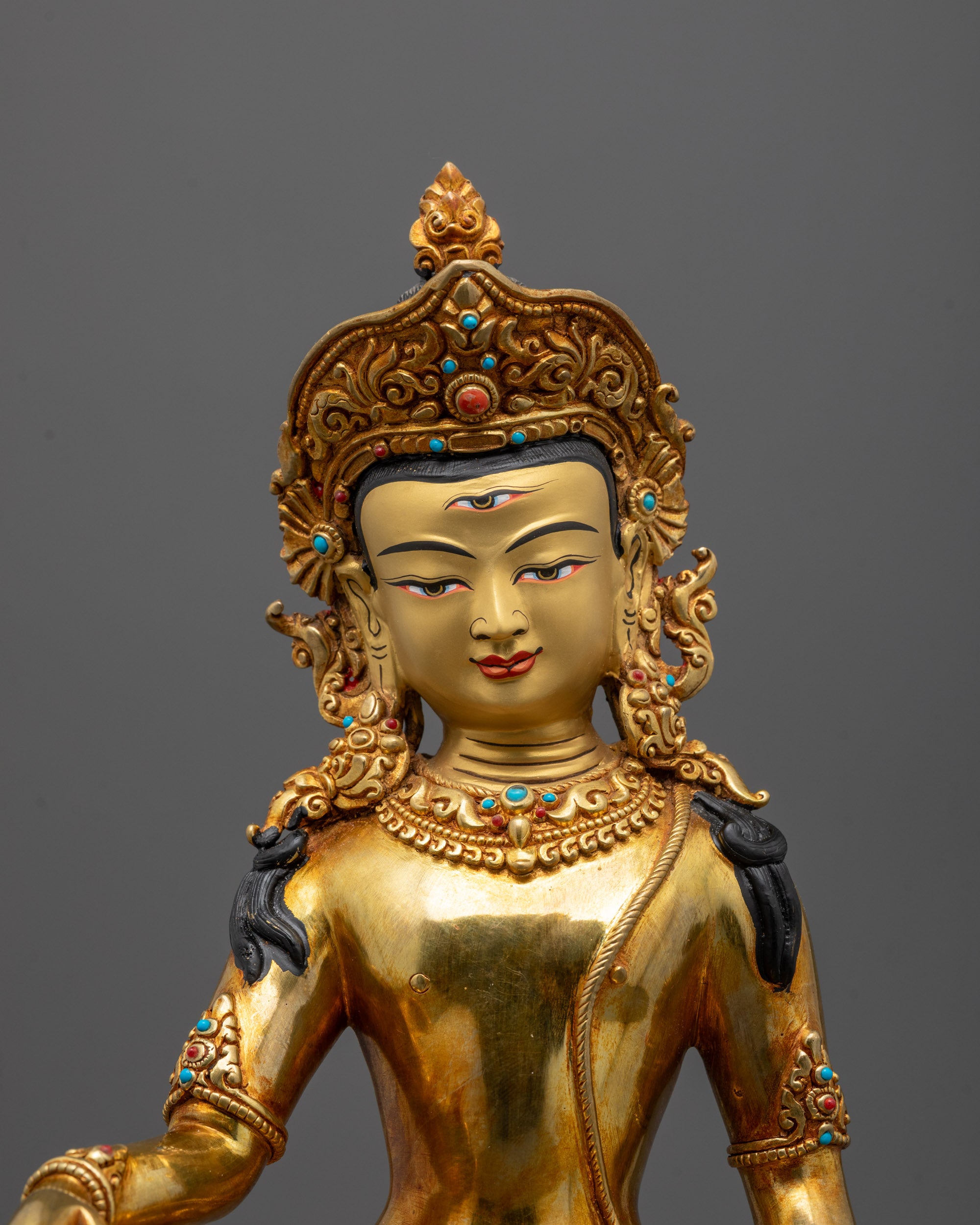 Close-up of Indra Statue’s third eye and intricate gold fire-gilded body carvings