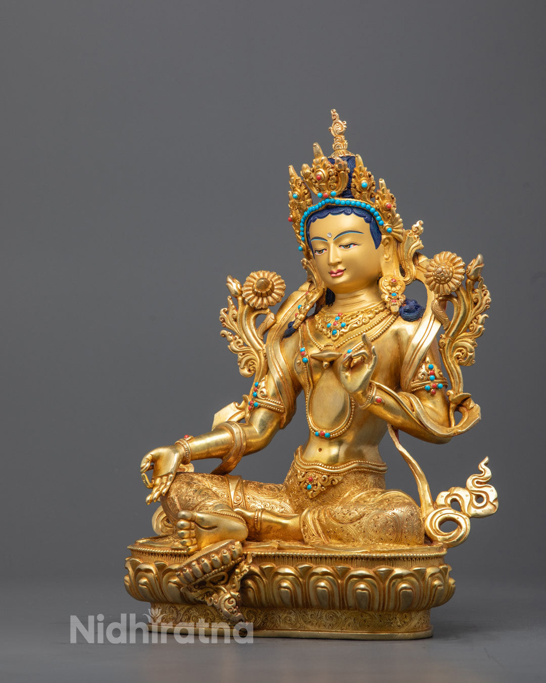 Intricate carvings on the back of Green Tara statue showcasing expert craftsmanship and gold gilding