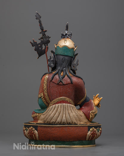 Intricate details of Guru Rinpoche statue’s robes and sacred implements with vibrant acrylic paint and gold gilding