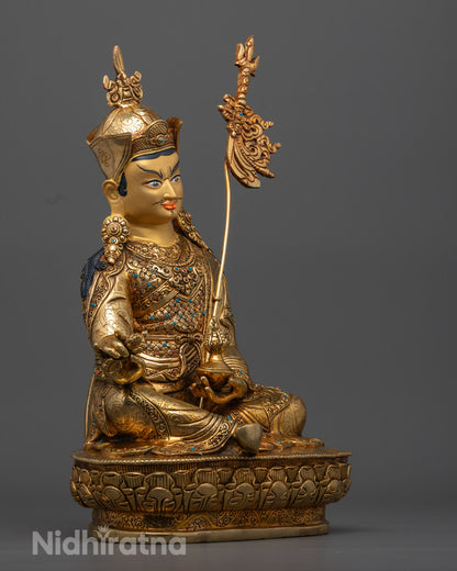 Intricately carved Guru Rinpoche statue adorned with semi-precious stones symbolizing protection and spiritual guidance