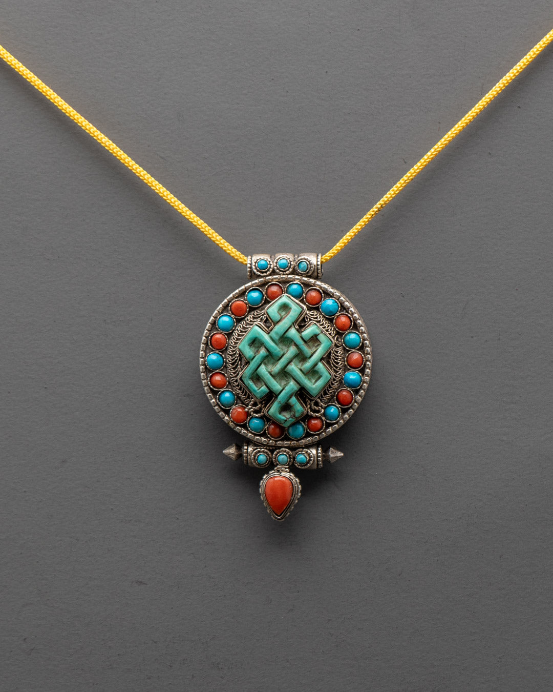 Intricately carved silver Infinity Knot Locket with filigree and semi-precious stones, Patan Nepal